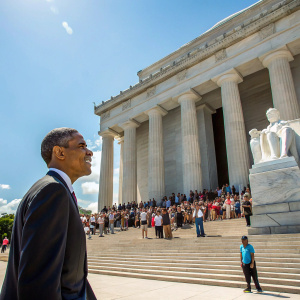 Former President Barack Obama touring the Lincoln Memorial. Crowd of visitors, sunny day.