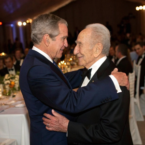 George W. Bush and Shimon Peres in a heartfelt embrace at a state dinner. Formal attire, white tablecloths, dignitaries seated