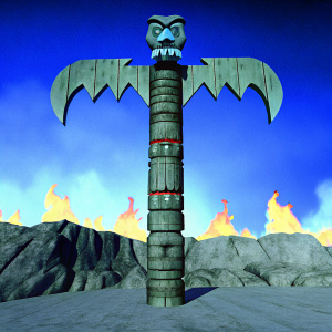 The colossal totem of Hir'eek, a fearsome entity from Incan mythology, stands guard in a desolate, fiery landscape. Its emerald-adorned wings and muscular form are set against a backdrop of raging flames, with a skull relic held aloft, encircled by jagged rocks, as the inferno's vibrant orange and yellow hues cast eerie shadows.