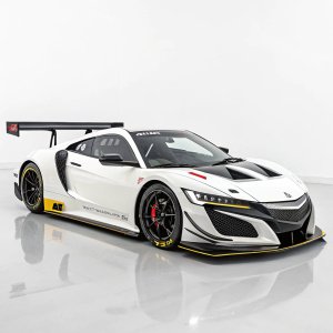 White Honda NSX GT300 on display at the Tokyo Motor Show. Sleek design, angular shape, black and yellow accents, large rear wing, black tires, plain white background