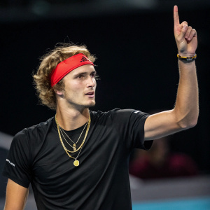 Alexander Zverev, Caucasian tennis player, intense look, curly hair, black shirt, gold necklace, red headband. Indoor tennis court, dark background, focused expression, raising one finger, high-quality photo style