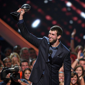 Andrew Luck, in a dark suit, accepting award at ESPYs. Crowd cheering