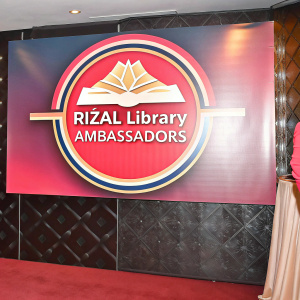 Dark blue backdrop with Rizal Library Ambassadors logo and contact details.