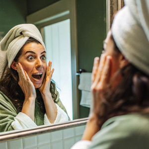 An image of her being surprised at how perfectly transformed her face has become after plastic surgery.