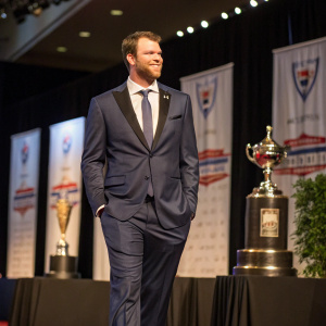 Chris Tillman, baseball player, wearing a custom suit. Award ceremony backdrop.