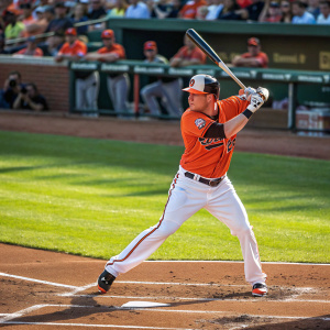 Mark Trumbo, baseball player, intense batting stance. Sunlit stadium background