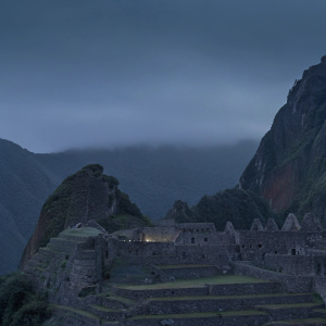 Ancient ruins of Machu Picchu, UNESCO World Heritage site. Lush greenery, stone structures, terraced landscape, nestled in Peruvian mountainside.