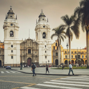 A panoramic view of the Basilica Cathedral of Lima, Peru. Located in the Plaza Mayor, the Roman Catholic church stands tall against a meticulously paved square.