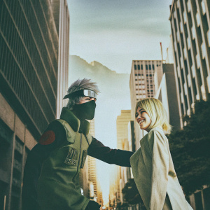 Digital illustration featuring Kakashi Hatake and a blonde-haired female character from Naruto. Set against a backdrop of a bustling cityscape with skyscrapers and distant mountains. The illustration is vibrant and detailed, emphasizing the characters' expressions and interaction.