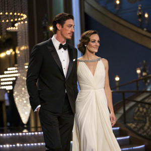 Eric Balfour and Erin Chiamulon attending a glamorous awards ceremony. They are both dressed in formal attire, Eric in a black tuxedo and Erin in a flowing white gown.