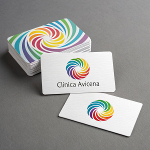 A variety of business cards showcasing the Clinica Avicena logo. Bright and dynamic spiral design. Neutral grey background.