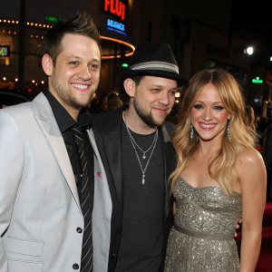 Joel Madden, Benji Madden, and Hilary Duff smiling and posing at the star-studded award show.