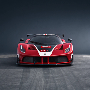 Digital artwork showcasing a sleek red Ferrari FXX K hypercar. White and black accents. Set against a dark grey backdrop. Highly detailed 3D rendering highlighting aerodynamic design and aggressive lines. Ferrari logo prominently displayed.