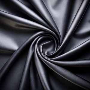 close up view black smooth fabric center fold background