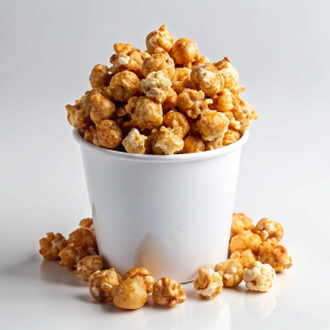 caramel popcorn on white bucket on white background