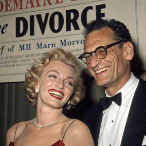 Headline: Marilyn Monroe and Arthur Miller Announce Divorce. Photo shows them smiling and appearing happy together.