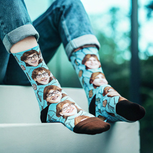 Digital illustration of a unique brown sock with a playful cartoon character featuring dollar signs. The sock design showcases a person's face and torso in intricate detail, positioned on a simple white backdrop.