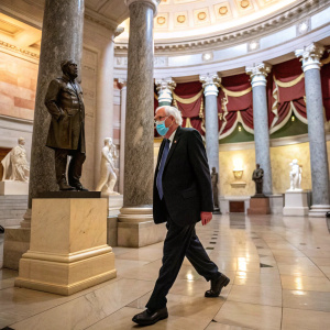 Bernie Sanders, in a mask, navigating a grand hall. Intricate marble columns and statues of historical figures line the corridor. Dark suit, indoor setting, official government building
