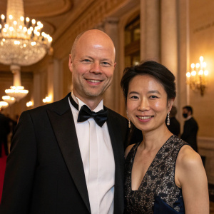 Sebastian Thrun and Doreen Xia at the Breakthrough Prize ceremony. Formal attire. Bald, bald head, smiling.
