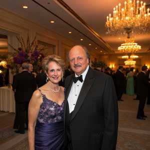 Dennis Franz and Joanie Zeck attending a gala. Formal attire, indoors with guests