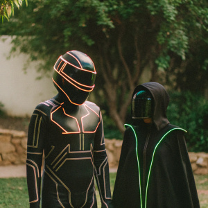Cyberpunk-inspired bodysuit and cloak, black in color, designed with Tron and Daft Punk motifs. On a plain background.