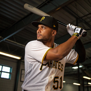 Jason Martin, Pittsburgh Pirates baseball player, intense look, wearing team jersey with number 51, black cap, and holding bat in batting stance. Indoor gym setting