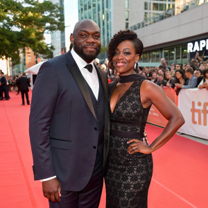 Omar Dorsey and Conisha Wade attending the Toronto International Film Festival. Wearing stylish evening wear. Crowd and red carpet visible in background.