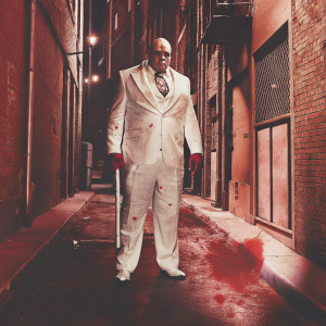 Comic book illustration. Kingpin, the villain, in a white suit with red splashes. A gritty, urban backdrop with a dark alleyway.