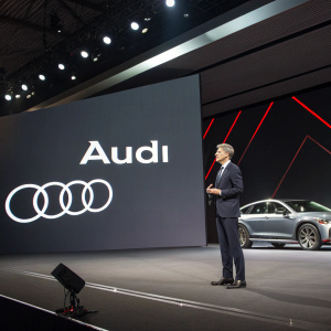 Concept for Audi's rebranding campaign. Sleek design with the new logo and visual identity. Strategic focus on marketing and branding. Professional tone. Clear font on dark background.
