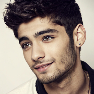 Close-up portrait of Zayn Malik, ex-One Direction member. Glamorous studio lighting, plain background