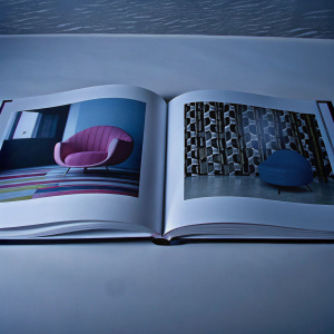 Karim Rashid's innovative furniture and interior designs showcased in a sleek, modern photo book. Vibrant colors and contemporary patterns dominate the pages, revealing his unique vision and commitment to creating spaces that harmonize with human life.