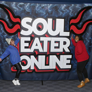 A vibrant banner featuring the 'Soul Eater Online' title in dynamic, stylized font. Set against a backdrop of swirling dark flames, the banner is adorned with cartoonish characters, each with unique and expressive features.
