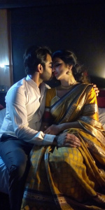 Indian beautiful actress teacher wearing a saree and showing her cleavage on bed,and sitting with husband by kissing him and hugging 
