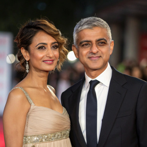 Mayor Sadiq Khan and Saadiya Khan in a blurred backdrop. Formal attire. Media event.