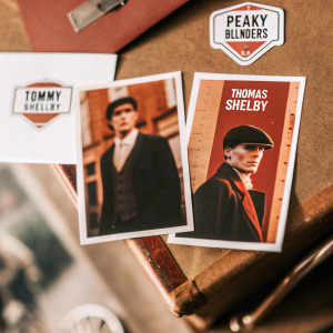 Sticker set featuring Tommy Shelby, Thomas Shelby, Peaky Blinders logo, 1920s era Birmingham backdrop. Black, white and brown color scheme.