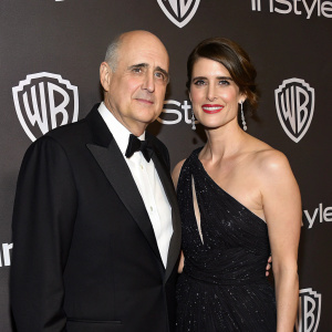 Jeffrey Tambor and Kasia Ostlun at the annual golden globes after-party. Elegant attire. Warner Bros logo backdrop