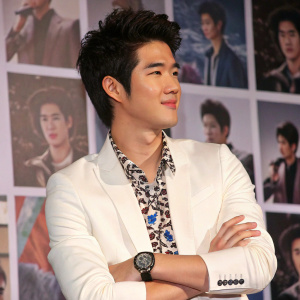 Mario Maurer, Thai actor, youthful appearance, dark tousled hair, white blazer over patterned shirt, watch on wrist. Press conference collage of images background