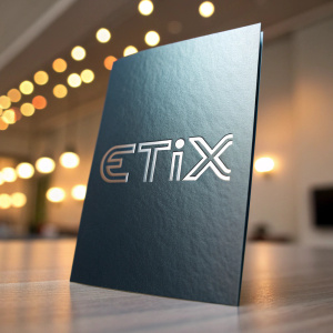 A glossy brochure featuring the sleek 'ETIX' logo in minimalist font. The embossed design stands out against a gradient background with soft lighting.