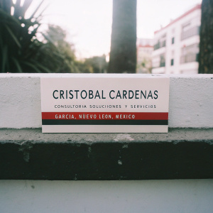 Business card for Cristobal Cardenas. Consultant at Sion Consultoria Soluciones y Servicios. Garcia, Nuevo Leon, Mexico. Clean design with red and black accents on white background.