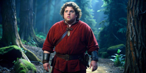 Genre: medieval fantasy
Shot: long
Lighting: midnight
Scene: Jonah in a dark forest
Side view
Character: Jonah Hill
Age: teenage, 18 years old, teenager
Appearance: fat, chubby cheeks, chubby
Build: fat body type, chubby, obese, fat face
Body: round, chubby, fat
Hair: black, shaggy
Shirt: burgundy, red, poor, peasant, tunic
Pants: brown, canvas
Boots: tall, leather, slip-on
Accessories: stone glove made of rock, belt, glass jar that is hanging from belt
Expression: scared, fearful, fear, afraid
