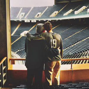 Carlo Ancelotti and James Rodríguez embracing in an empty stadium. Post-match interview setup. James wears jersey number 19.