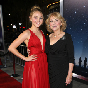 AnnaSophia Robb and Janet Robb gracing the Hollywood premiere. Glamorous evening attire. Starlit sky backdrop.