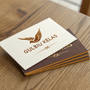 High-quality business cards for 'Gulbiu Kelias' on a wooden table. Swallow logo in brown, gold accents.