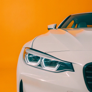 A modern photo of the BMW M4 Concept car. Sleek design, angular front end, unique LED headlights. Dark, dramatic background