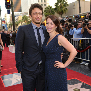 James Franco and Marla Sokoloff at the Hollywood Walk of Fame. Both in formal attire. Crowds and cameras surround them.