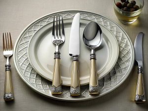 Formal cutlery ensemble knife fork spoon and plate arrangement