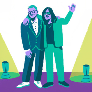 Diplo and Skrillex, the electronic music duo, at a Grammy Awards ceremony. They are dressed in formal attire. Diplo in a black suit and white shirt, Skrillex in a black outfit. Skrillex has his arm around Diplo in a friendly pose. The background is a simple red carpet with spotlights.