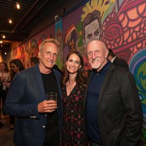 Patrick Fabian, Mandy Fabian, and Jonathan Banks celebrating at the 'Better Call Saul' finale party. The venue features a vibrant graffiti wall.