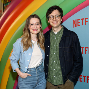 Gillian Jacobs and Paul Rust at the Netflix Party. They wear casual outfits, smiling against colorful streaming event backdrop.
