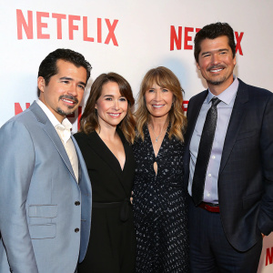 Formal gathering at Netflix event. John Leguizamo, Linda Cardellini, Sissy Spacek, and Kyle Chandler. Smiling in semi-formal attire in front of bright, Netflix-branded backdrop.
